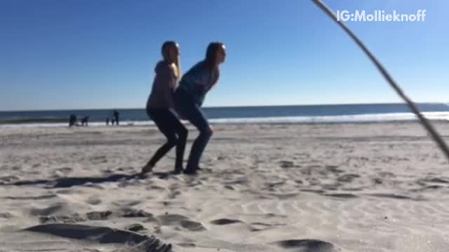 Girl trying to flip friend over faceplants