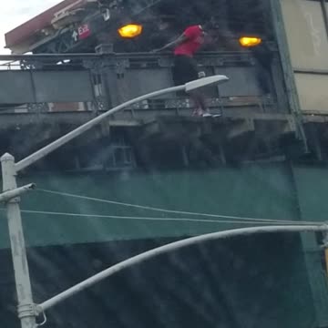 Guy red shirt standing on edge of bridge argument