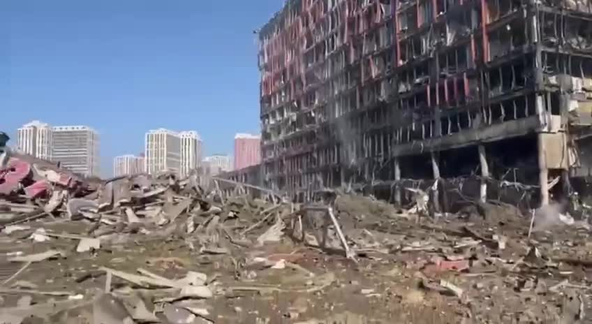 Burned-out shopping center which was being used as ammunition depot