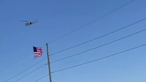 Helicopter with a massive flag accompanying US convoy for freedom en route to Washington.