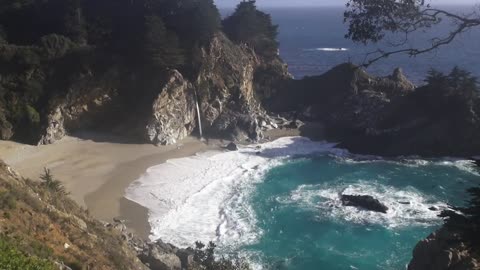 Waterfall on an Ocean Beach at Sunset