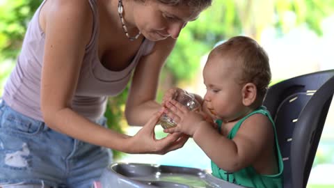Funny baby drinking juice