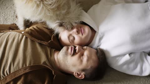 couple lying down with dog