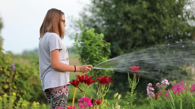 a girl watering her garden