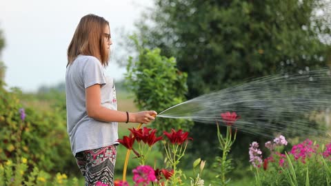 a girl watering her garden