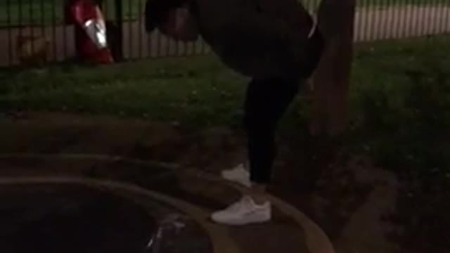 White shoes playground at night tries to slide and slips