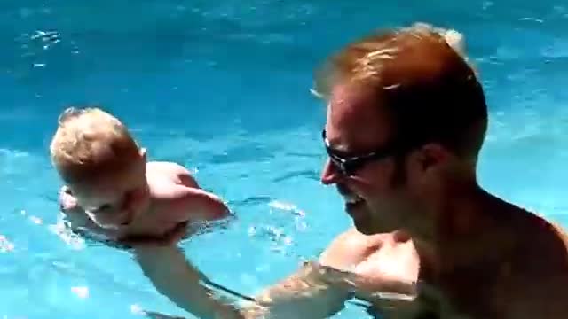 Baby in His First Swimming Lesson
