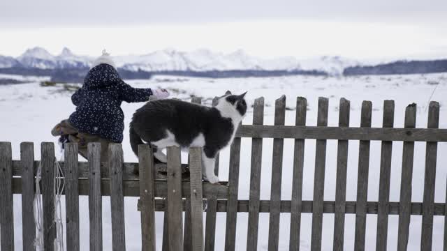 Girl with snow and cat