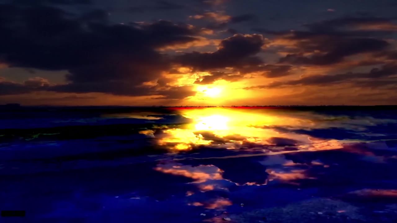 Beach With Rolling Waves with the sunrise burning through halfway.