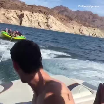 Girls on green tube on water girl falls