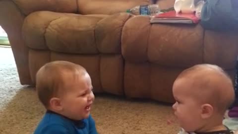 Twin babies have adorable fight