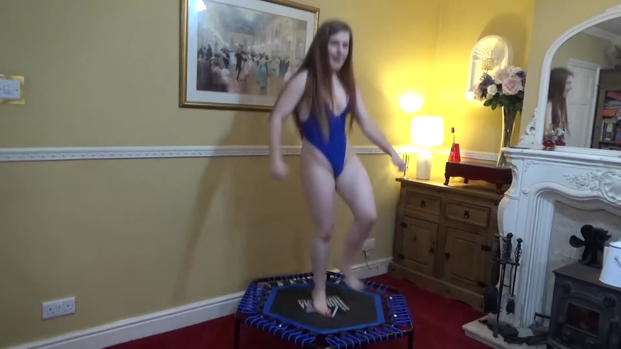 Aerobic trampoline routine wearing sexy hot blue body suit