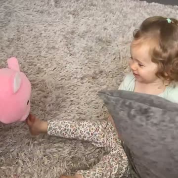 Adorable little girl plays peek-a-boo with pig!