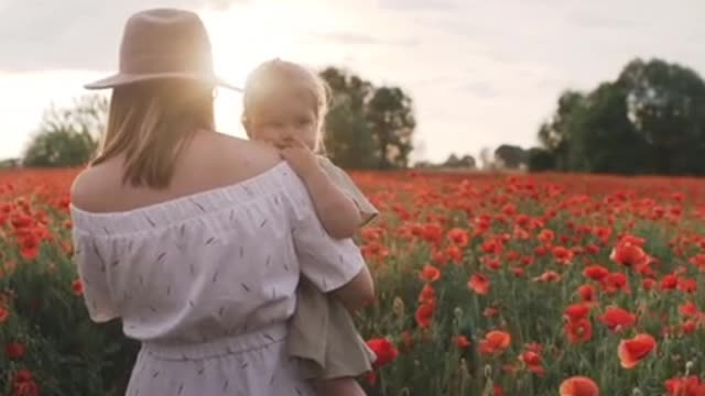 Cute baby with mom with flowers