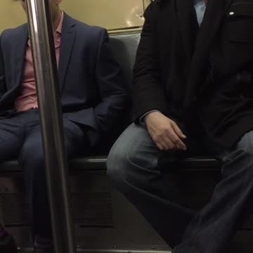 Two men falling asleep next to each other on train