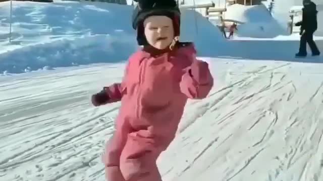 Child skiing on the ice with great emotion and drain