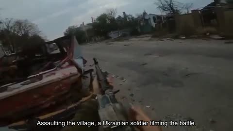 Assaulting the village, a Ukrainian soldier filming the battle.