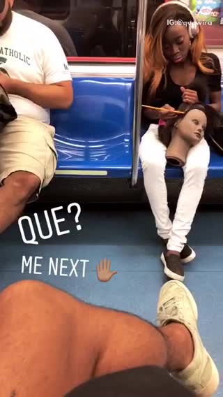 Girl pink beats headphones practicing on dummy head hair subway