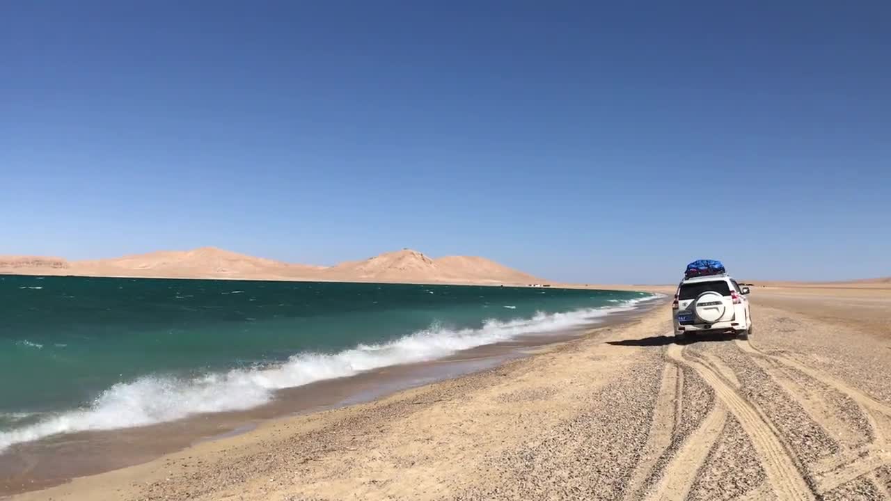 SUV driving along the seashore