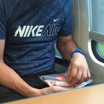 Guy blue shirt eating cold cuts out of plastic on subway