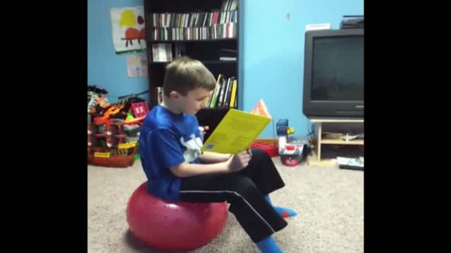 Reading Boy Surprised By Yoga Ball