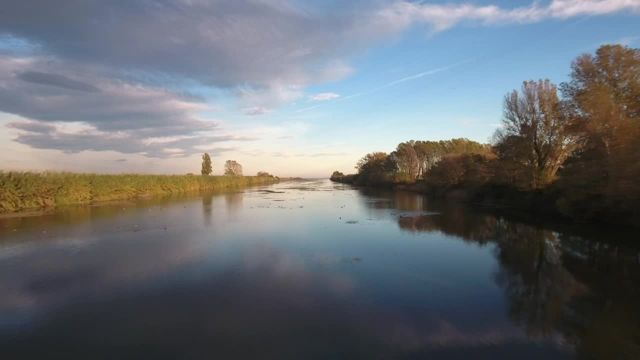 Sailing a quiet river in autumn