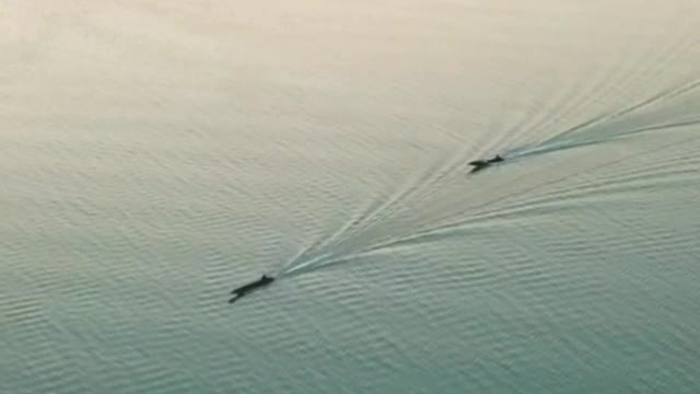 Two speedboats on a lake seen from the air