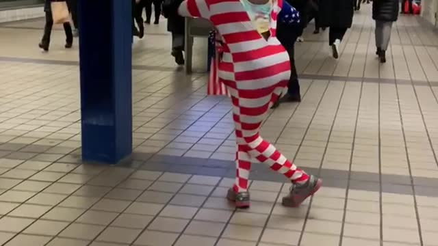 Man with donald trump mask american flag outfit dancing