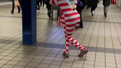 Man with donald trump mask american flag outfit dancing