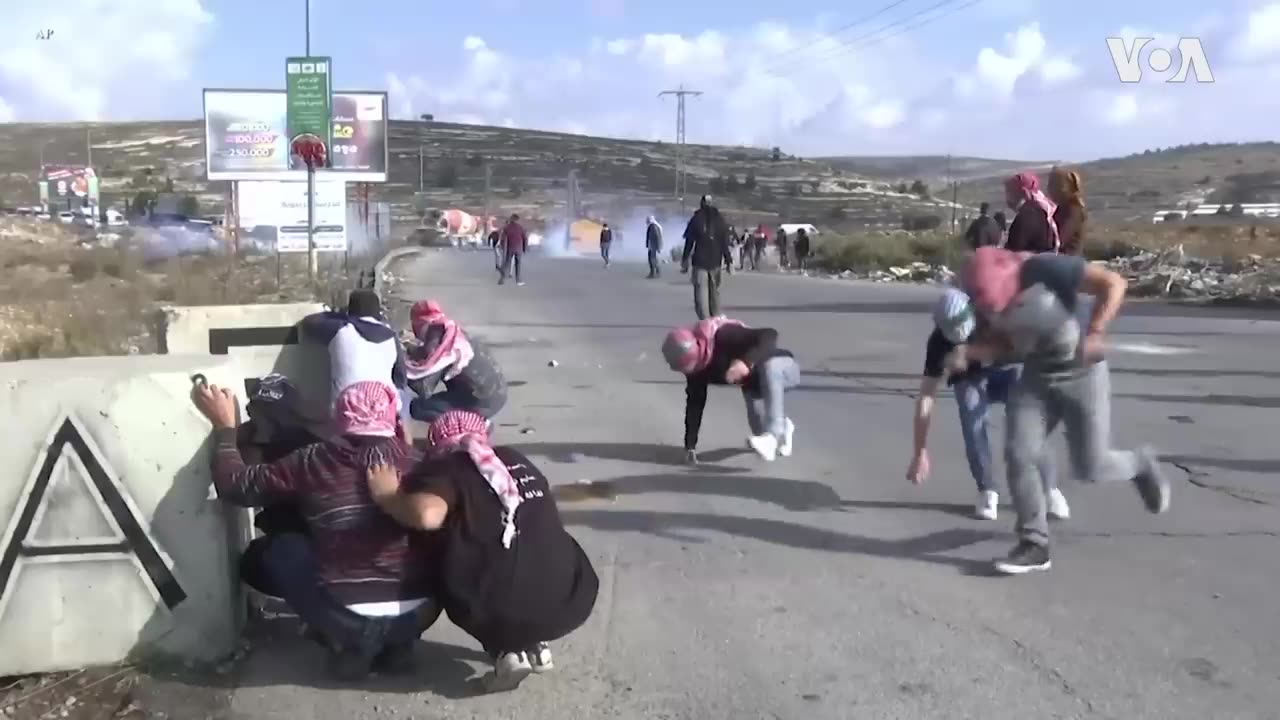 Palestinian protesters clash with Israeli soldiers..