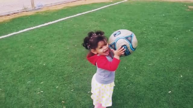 This child does not know that the ball is bigger than her