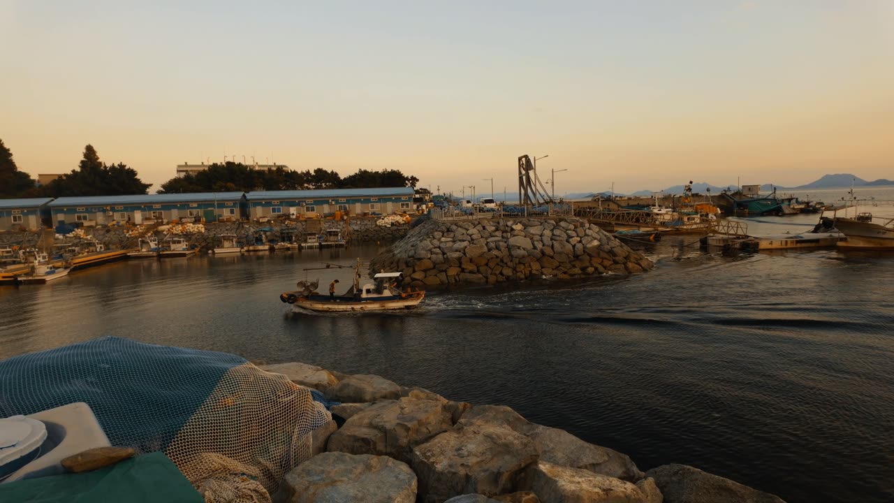 "Golden Sunset Over a Fishing Boat in Yeosu's Coastal Village"