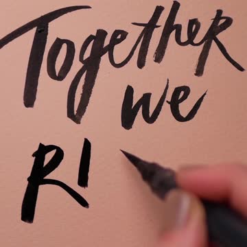 A Person Writing a Slogan