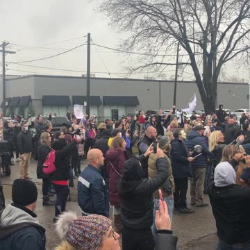 Protestors play the national anthem outside of Adamson BBQ