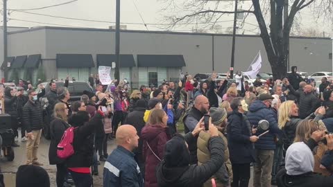 Protestors play the national anthem outside of Adamson BBQ