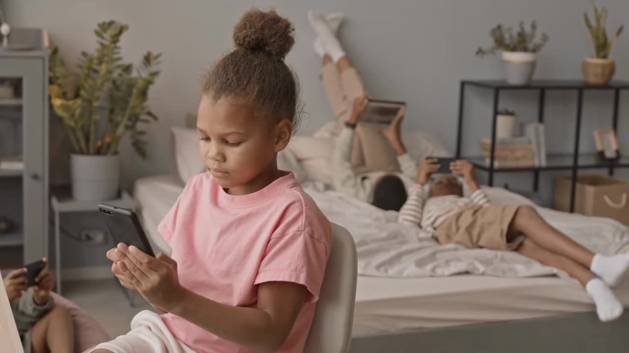 Medium slowmo shot of 8-year-old African-American girl scrolling