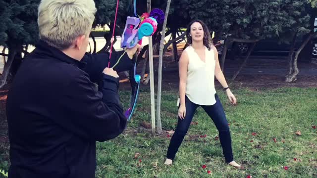 Girl Catches Rose Shot From Bow And Arrow In Mouth