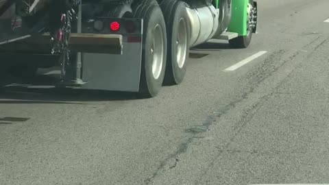 Semi Pushes Car Along Highway