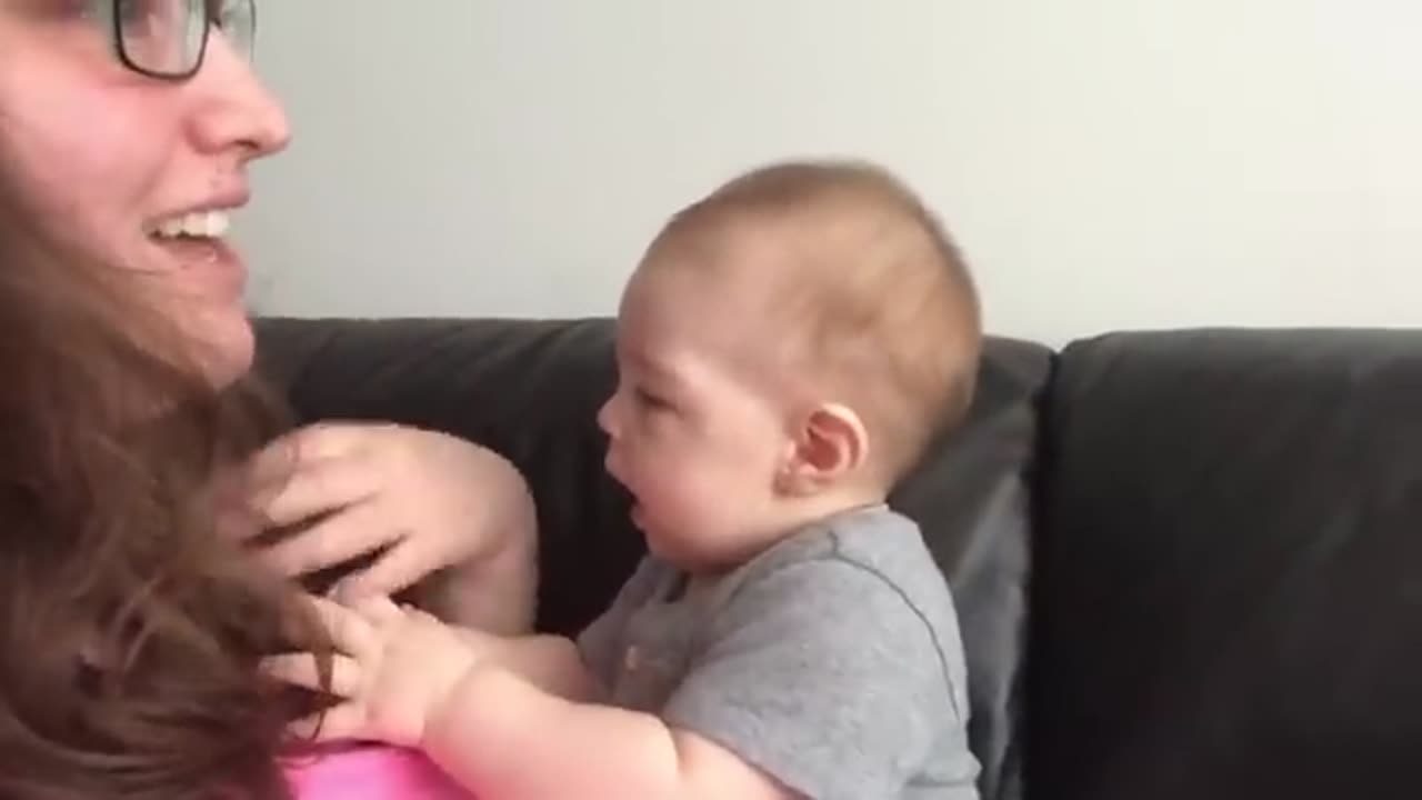 Cute baby's reaction to his mom's singing