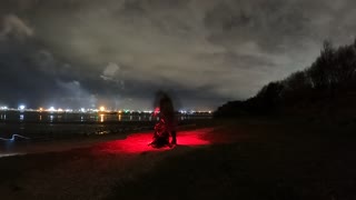 Night lapse. Setti g up the Trekology Yizo go camping chair. Next to ti a river at night.