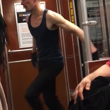 Bald guy blue tank top dancing on subway