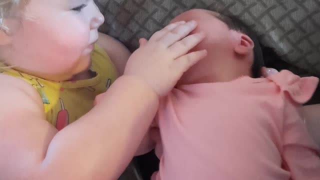 Holding Her Newborn Sister for the First Time