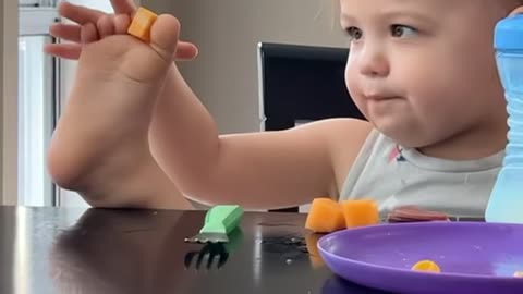 Toddler Eats Cheese from Her Toes