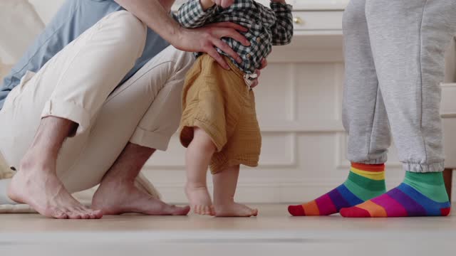 Babies first step moment with its parents