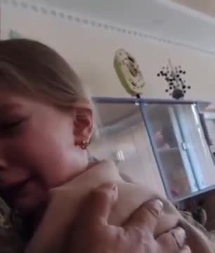 Ukrainian soldier gets to hug his daughter in her classroom.