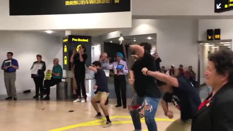 Maori family greets their siblings at the airport in a cultural way.