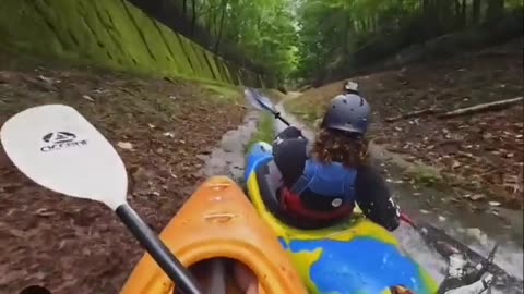 3 Kayakers going down a hill at breakneck speed