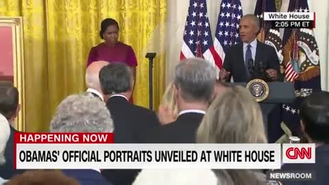 Barack Obama gives a speech after the unveiling of his White House portrait