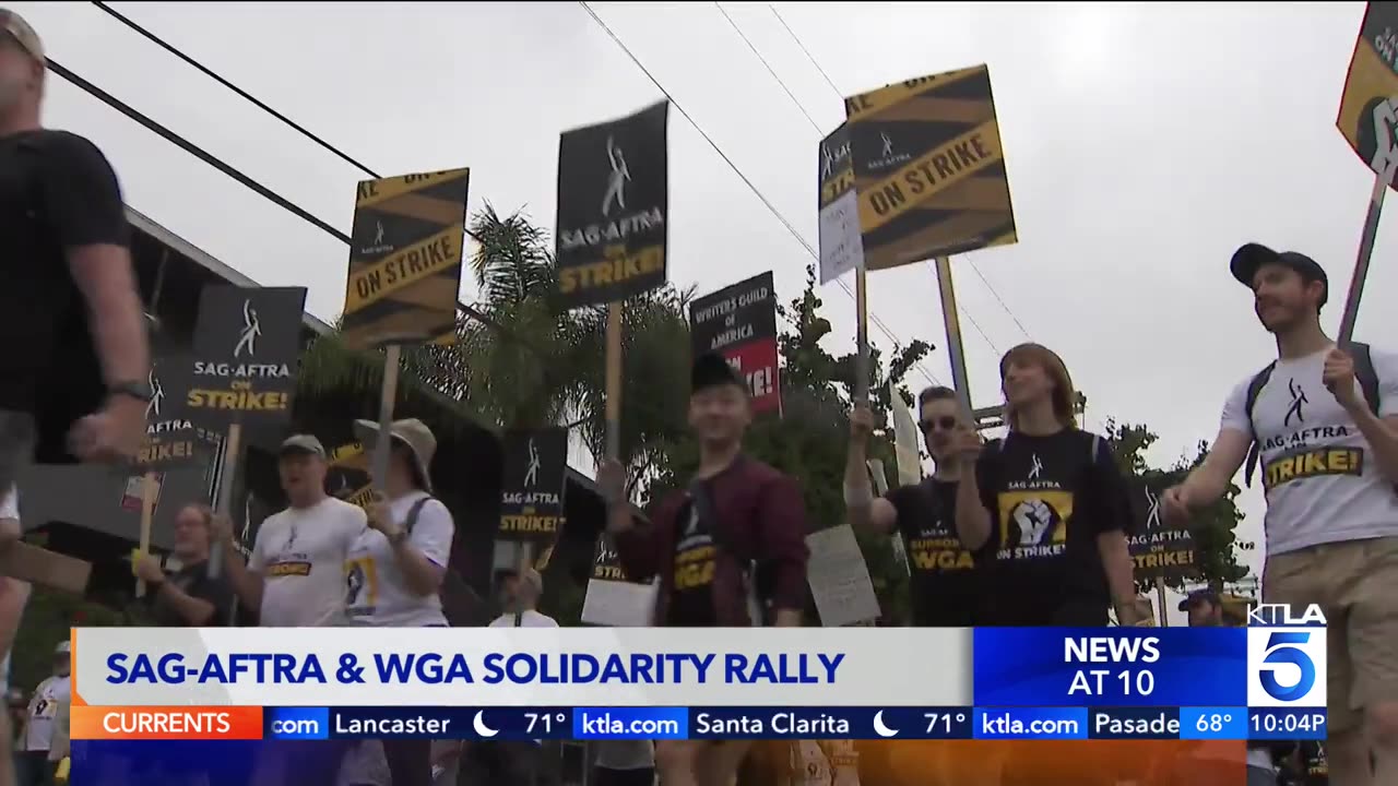 Writers and actors march through Hollywood as strikes continue