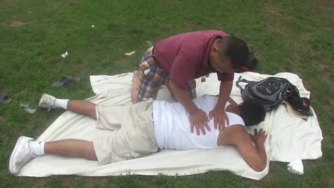 Luodong Massages Man In Under-Shirt At The Park